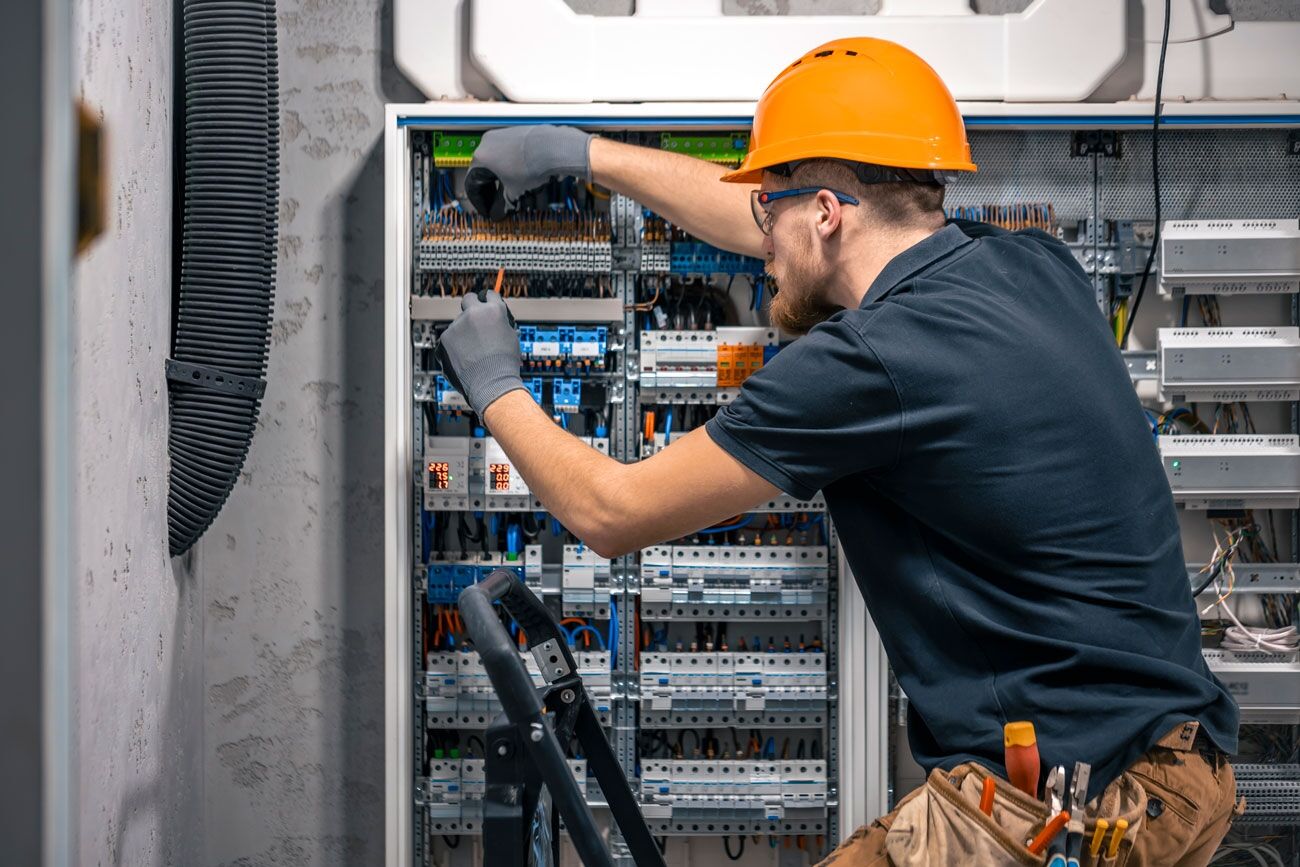male-electrician-working-in-a-switchboard-with-fus-2024-05-10-05-22-37-utc2